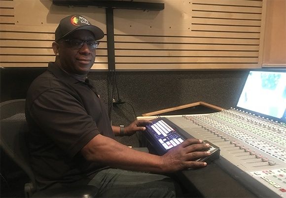 Ljudtekniker arbetar vid en stor mixerpanel i en ljudstudio